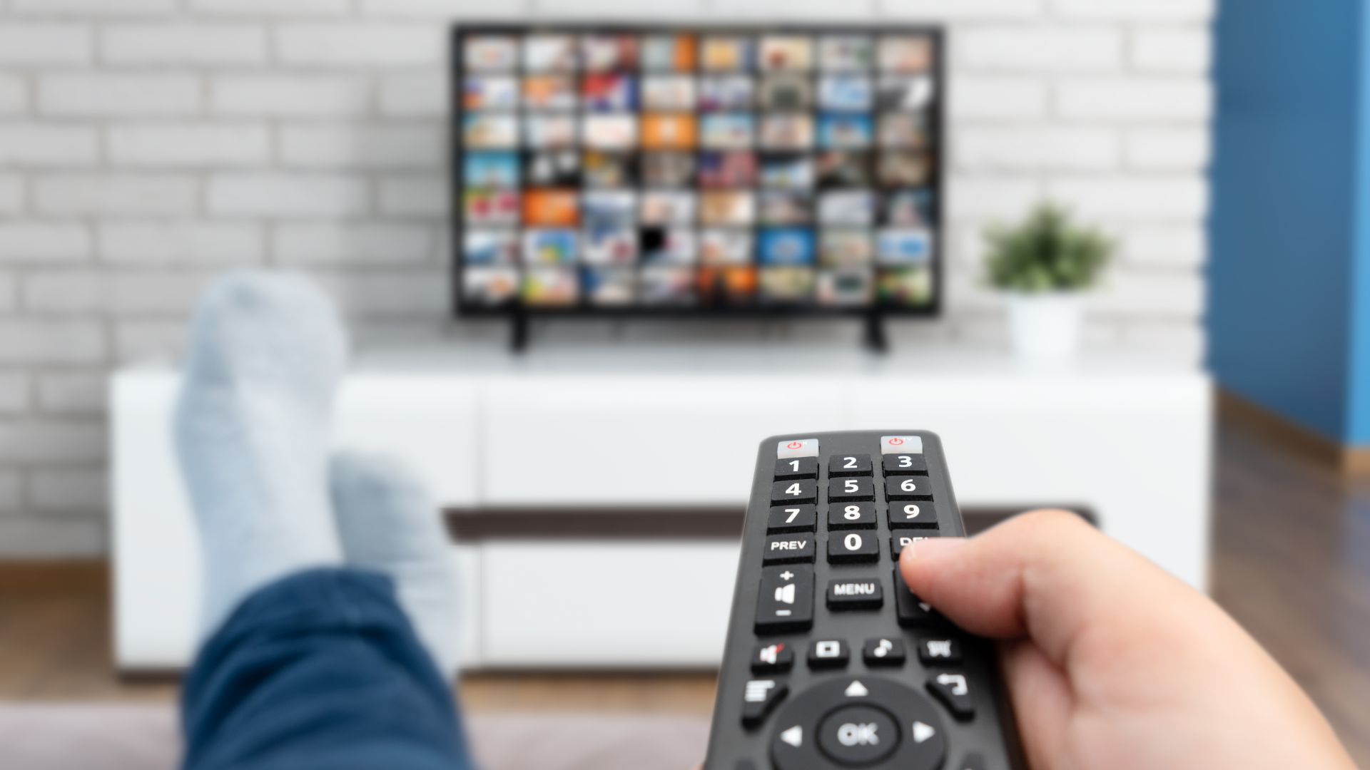 Amazon Prime user pointing remote towards TV.