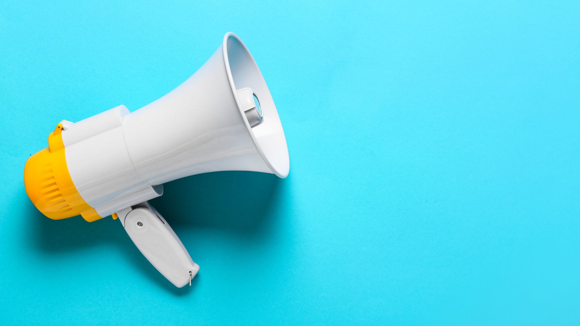 White and yellow megaphone on blue background.