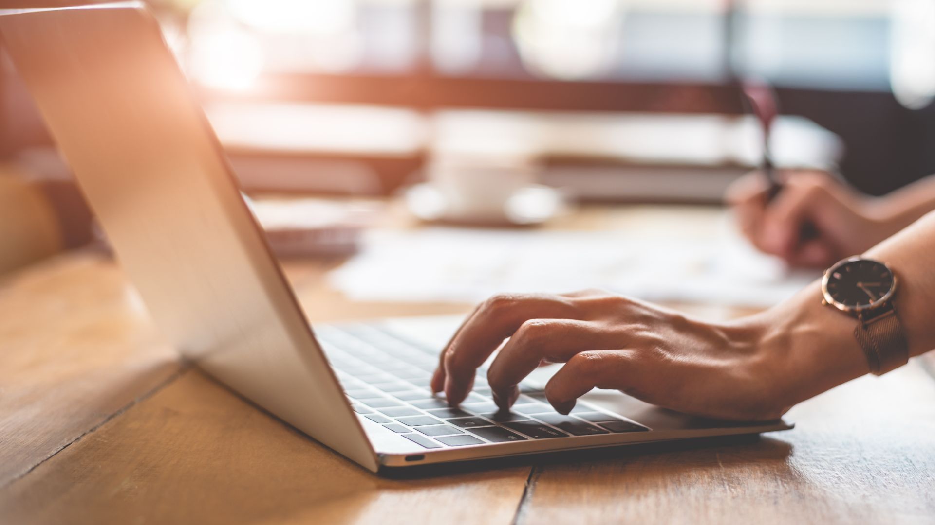 Person typing on laptop.