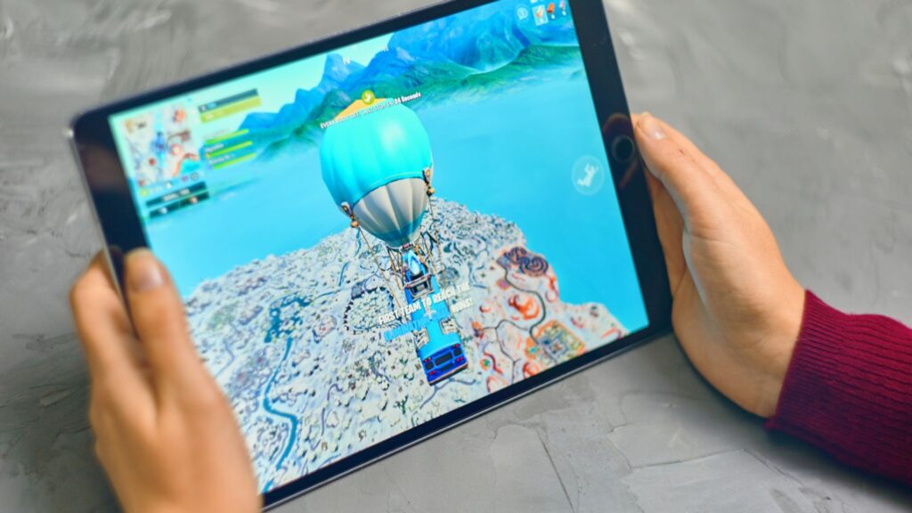 Person playing game on tablet.