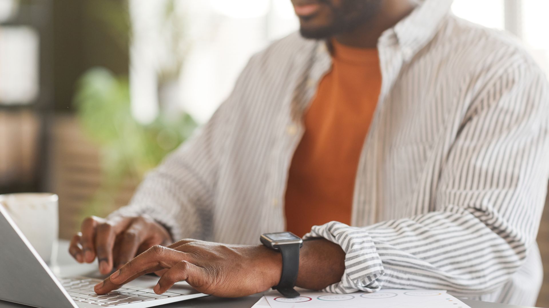 Man typing on laptop.